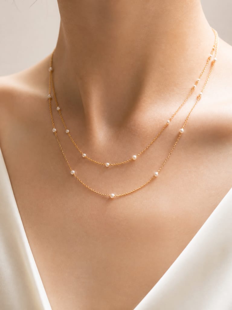 Layered gold necklace with tiny pearls on the neckline